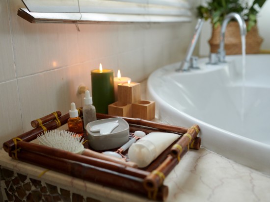 Łazienka przygotowana do wieczornej pielęgnacji. Na umywalce stoi taca z akcesoriami i kosmetykami.